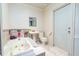 Bright bathroom with tub, sink, toilet, tile floors, and a door to the exterior at 35 Knollwood Estates Dr, Ormond Beach, FL 32174
