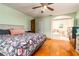 Bedroom with wooden floors leading to ensuite bathroom with an arched doorway at 35 Knollwood Estates Dr, Ormond Beach, FL 32174