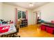 Bright bedroom with wood floors, large closet with mirrored doors, and natural light at 35 Knollwood Estates Dr, Ormond Beach, FL 32174