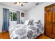 Bedroom featuring hardwood floors, ceiling fan, and patterned duvet at 35 Knollwood Estates Dr, Ormond Beach, FL 32174
