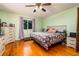 Bedroom with wood floors, neutral walls and white dresser at 35 Knollwood Estates Dr, Ormond Beach, FL 32174