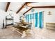 Bright dining room features a large wooden table, bench seating, and natural light at 35 Knollwood Estates Dr, Ormond Beach, FL 32174