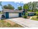 Attractive home features a spacious driveway leading to a two-car garage and well-kept front yard at 35 Knollwood Estates Dr, Ormond Beach, FL 32174