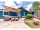 Back patio with outdoor seating, a large umbrella, and tropical landscaping at 35 Knollwood Estates Dr, Ormond Beach, FL 32174