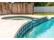 Close up of pool's spa detailing with blue mosaic tiles cascading into pool at 35 Knollwood Estates Dr, Ormond Beach, FL 32174