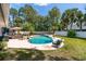 Pool area with ample space for seating and relaxing in the backyard oasis at 35 Knollwood Estates Dr, Ormond Beach, FL 32174
