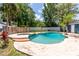 Backyard pool area with grass and mature trees and wooden privacy fence at 35 Knollwood Estates Dr, Ormond Beach, FL 32174