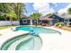 An eye-level view of a uniquely shaped pool and fenced in yard at 35 Knollwood Estates Dr, Ormond Beach, FL 32174