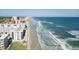 An aerial view of a beachfront condo, sandy beach, and Atlantic ocean at 4151 S Atlantic Ave # 414, New Smyrna Beach, FL 32169