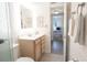 Well-lit bathroom featuring a vanity with mirror and a view into an adjacent bedroom at 4151 S Atlantic Ave # 414, New Smyrna Beach, FL 32169