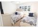 Cozy bedroom featuring two beds with elegant bedding, a ceiling fan, and neutral walls at 4151 S Atlantic Ave # 414, New Smyrna Beach, FL 32169