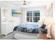Bright bedroom showcasing a large window, flat screen tv, and a comfortable bed with a stylish floral pattern comforter at 4151 S Atlantic Ave # 414, New Smyrna Beach, FL 32169