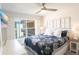 A cozy bedroom with ceiling fan and view of resort at 4151 S Atlantic Ave # 414, New Smyrna Beach, FL 32169