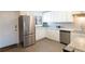 A well-lit kitchen features stainless steel appliances, white cabinets, and granite countertops at 4151 S Atlantic Ave # 414, New Smyrna Beach, FL 32169