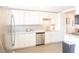 Modern kitchen with white cabinets, stainless steel appliances, and granite countertops at 4151 S Atlantic Ave # 414, New Smyrna Beach, FL 32169