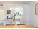 Modern kitchen with white cabinets and stainless steel appliances, open to the living and dining areas at 4151 S Atlantic Ave # 414, New Smyrna Beach, FL 32169