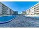 Beautiful pool area with lounge chairs and tables for residents enjoyment at 4151 S Atlantic Ave # 414, New Smyrna Beach, FL 32169