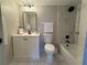 Bright bathroom featuring a white vanity, black hardware, and marble tiled shower and tub at 4175 S Atlantic Ave # 5280, New Smyrna Beach, FL 32169