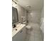 Modern bathroom featuring marble tiled shower and new fixtures and vanity at 4175 S Atlantic Ave # 5280, New Smyrna Beach, FL 32169