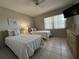 Bright bedroom featuring two twin beds, nautical decor, and window with blinds at 4175 S Atlantic Ave # 5280, New Smyrna Beach, FL 32169
