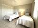 Bright bedroom featuring two twin beds, nautical decor, and ample closet space at 4175 S Atlantic Ave # 5280, New Smyrna Beach, FL 32169