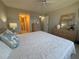 Bright bedroom with a view of the bathroom, dresser and comfy bedspread at 4175 S Atlantic Ave # 5280, New Smyrna Beach, FL 32169