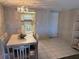 Cozy dining area featuring a table with seating for four and an elegant light fixture at 4175 S Atlantic Ave # 5280, New Smyrna Beach, FL 32169