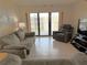 Comfortable living room with sliding glass doors to balcony and neutral-toned furniture at 4175 S Atlantic Ave # 5280, New Smyrna Beach, FL 32169