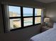 Bedroom window frames a view of the beach and pool at 4175 S Atlantic Ave # 5280, New Smyrna Beach, FL 32169