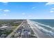 Breathtaking aerial shot of oceanfront buildings and beach, capturing the coastal scenery and vibrant community at 4201 S Atlantic Ave # 402, New Smyrna Beach, FL 32169