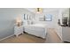 Cozy bedroom with carpet, soft lighting, and ocean-themed artwork above the bed at 4201 S Atlantic Ave # 402, New Smyrna Beach, FL 32169