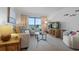 Bright living room boasts comfortable seating, coastal decor, and access to the balcony with ocean views at 4201 S Atlantic Ave # 402, New Smyrna Beach, FL 32169