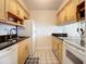 Efficient kitchen featuring light wood cabinets and black countertops at 4225 S Atlantic Ave # 218, New Smyrna Beach, FL 32169