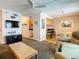 Relaxing living room featuring a TV, ceiling fan, and view into dining area at 4225 S Atlantic Ave # 218, New Smyrna Beach, FL 32169