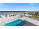 Aerial view of pool with lounge chairs, beach access and ocean views at 425 S Atlantic Ave # 302, New Smyrna Beach, FL 32169