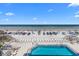 Elevated view showcasing a pool area and an ocean view with beach access at 425 S Atlantic Ave # 302, New Smyrna Beach, FL 32169