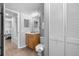 Cozy bathroom with a sink, toilet, mirror, vanity lighting, and shower with curtain at 425 S Atlantic Ave # 302, New Smyrna Beach, FL 32169