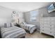 Bright and cozy bedroom featuring two twin beds, a dresser, and a flat screen television at 425 S Atlantic Ave # 302, New Smyrna Beach, FL 32169