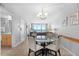 Well-lit dining area with a glass table, seating for four, and an ocean view at 425 S Atlantic Ave # 302, New Smyrna Beach, FL 32169