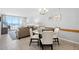 Dining area adjacent to living room featuring ocean views and access to the balcony at 425 S Atlantic Ave # 302, New Smyrna Beach, FL 32169