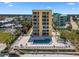 Bright yellow condo building with a pool deck, ocean views, and a beach just steps away at 425 S Atlantic Ave # 302, New Smyrna Beach, FL 32169