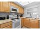 Well-lit kitchen with modern appliances, light wood cabinets, and a neutral color scheme at 425 S Atlantic Ave # 302, New Smyrna Beach, FL 32169