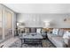 Cozy living room with comfortable grey sofas, beach themed decor and balcony access at 425 S Atlantic Ave # 302, New Smyrna Beach, FL 32169