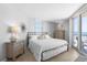 Bright main bedroom with beach view balcony, white linens, and decorative furnishings at 425 S Atlantic Ave # 302, New Smyrna Beach, FL 32169