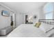 Bright main bedroom featuring beach view television, modern lamps, and cozy decor at 425 S Atlantic Ave # 302, New Smyrna Beach, FL 32169