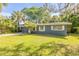 Charming single-story home with a well-maintained lawn and mature landscaping at 431 Palmetto St, Edgewater, FL 32132
