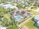 Aerial shot of property featuring a screened pool and solar panels at 4350 Candlewood Ln, Ponce Inlet, FL 32127