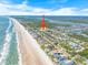 Scenic aerial view of a coastal neighborhood with beach access and beautiful ocean scenery at 4350 Candlewood Ln, Ponce Inlet, FL 32127