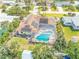 Aerial view of home with screened-in pool and solar panels at 4350 Candlewood Ln, Ponce Inlet, FL 32127