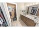Functional bathroom featuring a vanity with drawers, a mirror, and an adjacent shower at 4350 Candlewood Ln, Ponce Inlet, FL 32127